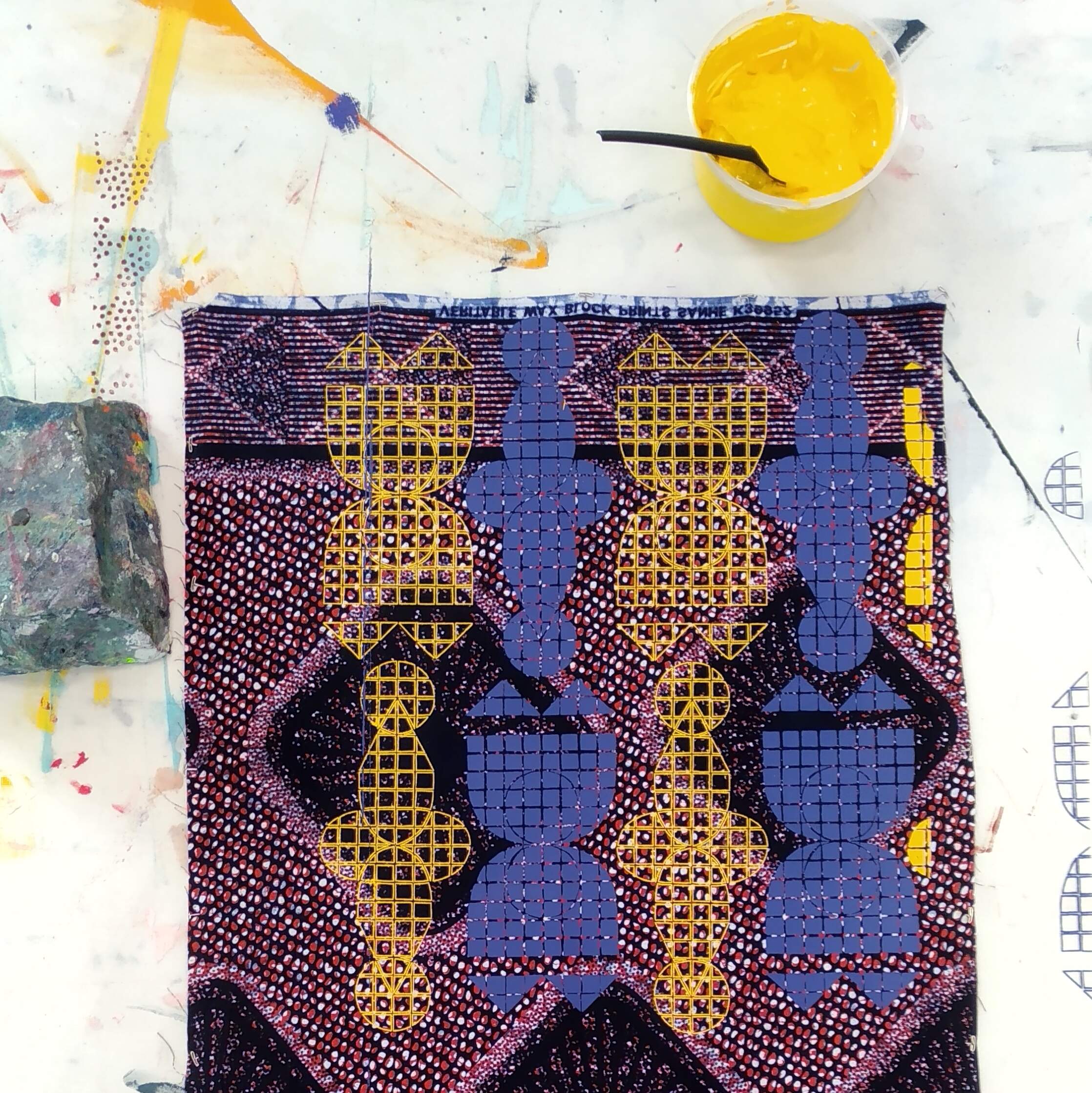 Yellow and blue pattern screenprinted on cotton wax fabric.
